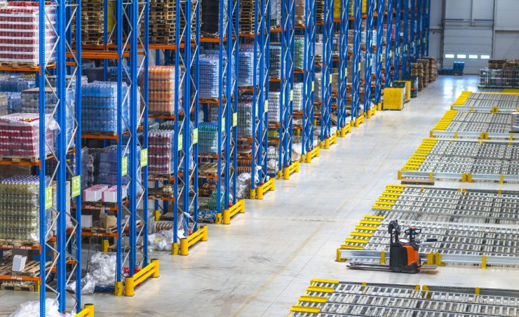 Distribution warehouse building interior and large storage area with goods on the shelf.