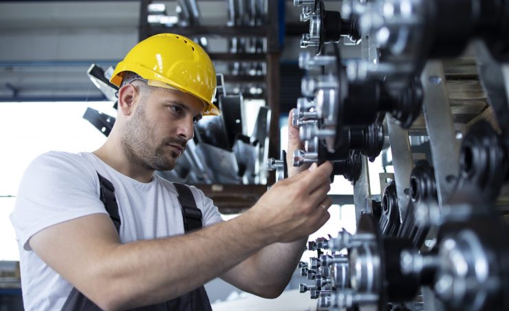 Industrial worker working at production line in factory.